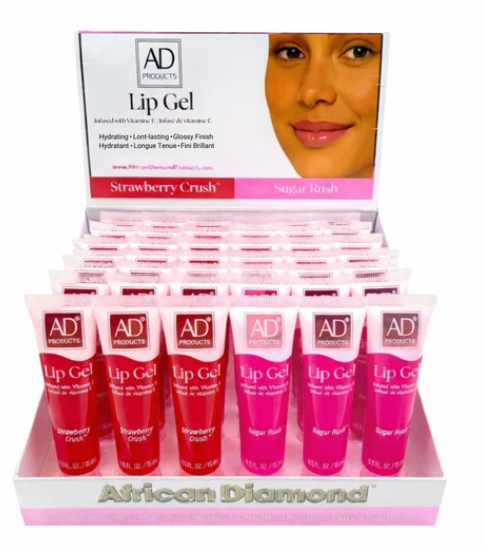 A retail display box filled with small pink and red tubes of AD Products Lip Gel, with the front tube labeled Strawberry Crush and Sugar Rush. The display box and back card show the AD Products branding and a model's face on the packaging.