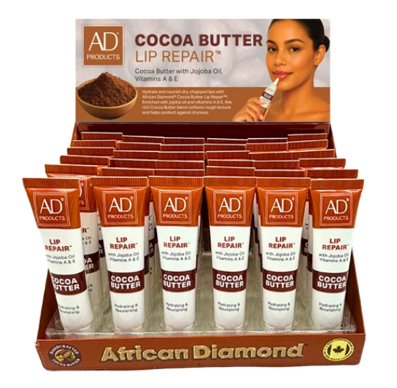 A retail display box filled with small tubes of AD Products Cocoa Butter Lip Repair. The packaging features brown and white tubes with the brand name 'AD PRODUCTS' and 'COCOA BUTTER LIP REPAIR' printed on them.