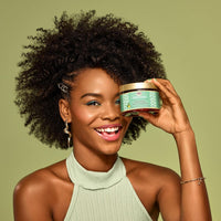 Thumbnail for Woman holding a jar of hair care product against a green background