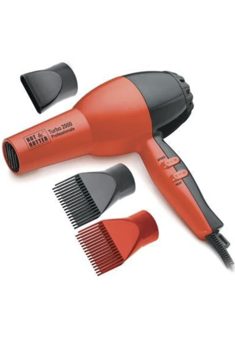 Red hair dryer with attachments on a white background