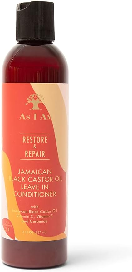 A bottle of As I Am Jamaican Black Castor Oil Leave In Conditioner, featuring a dark amber bottle and a red and orange label with a black cap, set against a plain white background.