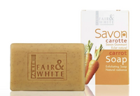 Thumbnail for A rectangular bar of Fair & White carrot exfoliating soap in a warm tan-brown color, shown next to its white and orange cardboard packaging box featuring illustrations of carrots.