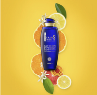 Thumbnail for A bottle of Fair & White Glycerin Exclusive Whitizer in a deep blue bottle with a gold cap, styled on a bright yellow background with citrus slices, grapefruit slices, and green leaves.
