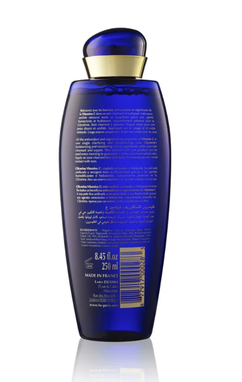 A 250 ml bottle of La Prairie’s Ultra Cellular Serum, shown from the back on a white background with a subtle reflection. The bottle is a deep cobalt blue with a metallic gold collar and features white text and a gold barcode.