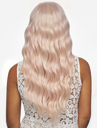 Thumbnail for Person with long, wavy, light blonde hair wearing a white lace top on a light beige background