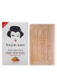 Thumbnail for Kojie San Kojic Acid Soap shown next to its white packaging box, featuring a stylized black woman's face logo and a light peach-beige soap bar embossed with the brand name.