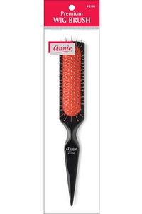 Thumbnail for A wig brush with a black handle and red bristles, packaged in a clear plastic casing with a label that reads 'Annie' and 'Premium Wig Brush'.