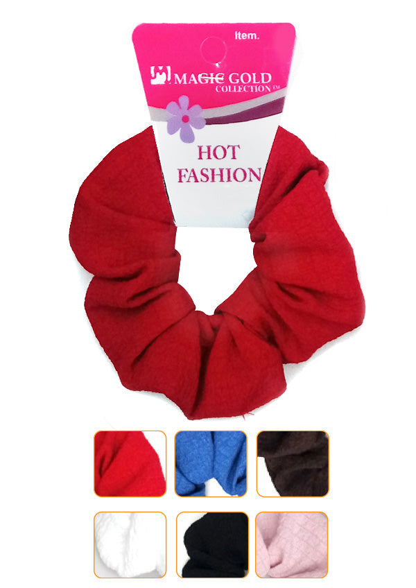 A red fabric scrunchie with a pink and white 'MAGE GOLD COLLECTION' retail header card, shown on a white background with six color-option swatches along the bottom.