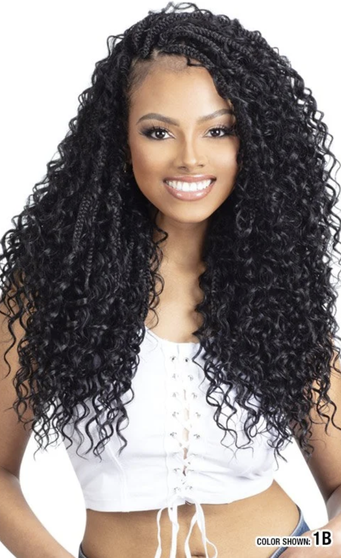 Woman with long, curly black hair wearing a white top on a white background
