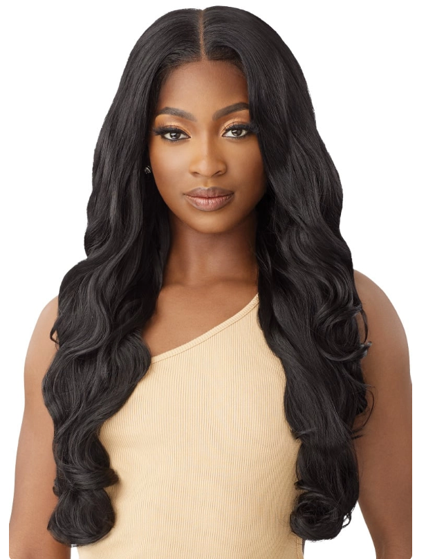 Woman with long, wavy black hair wearing a beige top on a white background