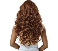 Thumbnail for A woman shown from the back wearing a long, wavy wig with a warm medium brown root and caramel highlights, paired with a beige top and light denim shorts against a solid white background.