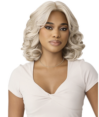 Thumbnail for Woman with styled blonde hair wearing a white top on a white background