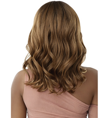 Thumbnail for A woman shown from the back wearing a shoulder-length wavy wig with warm medium brown and golden blonde highlights, paired with a dusty pink one-shoulder top against a plain white background.