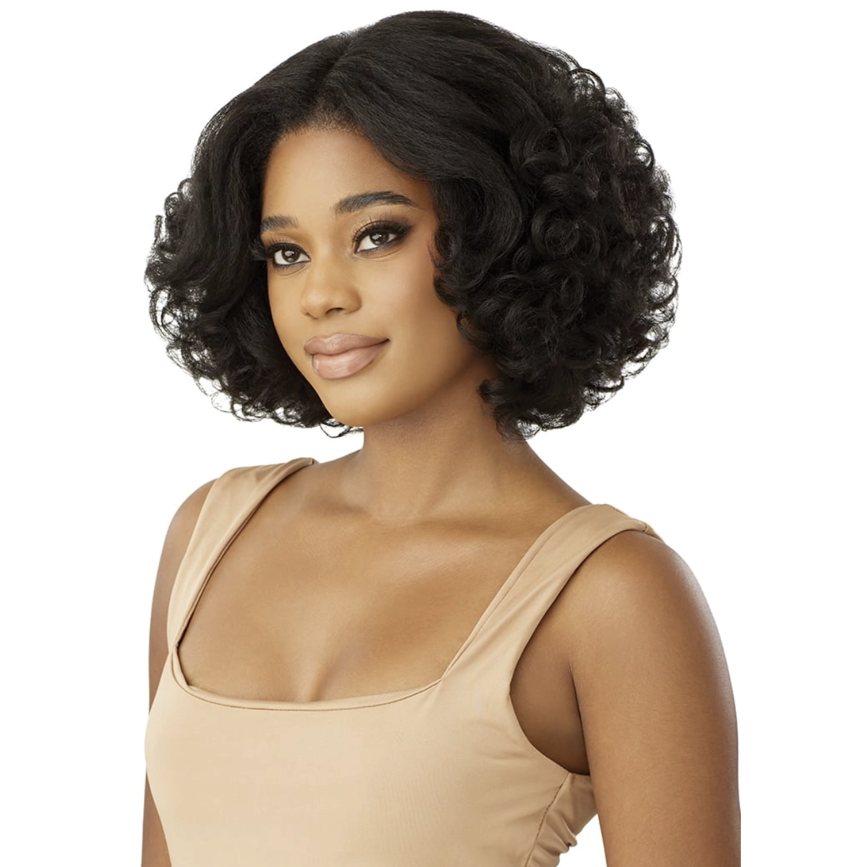 A woman modeling a short, curly black wig against a plain white background. She is wearing a beige tank top.