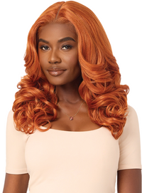 Thumbnail for Woman with long, wavy orange hair wearing a beige top on a white background