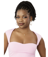 Thumbnail for A woman with braided hair wearing a light pink strapless top, gold hoop earrings, and a delicate necklace, shown against a plain white background.