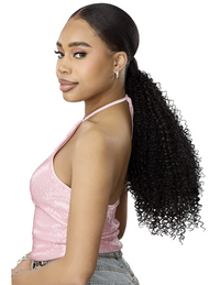 Thumbnail for A woman with long, dark, curly hair in a low ponytail, wearing a sparkling light pink halter top and denim jeans, shown from a side-back profile against a solid white background.