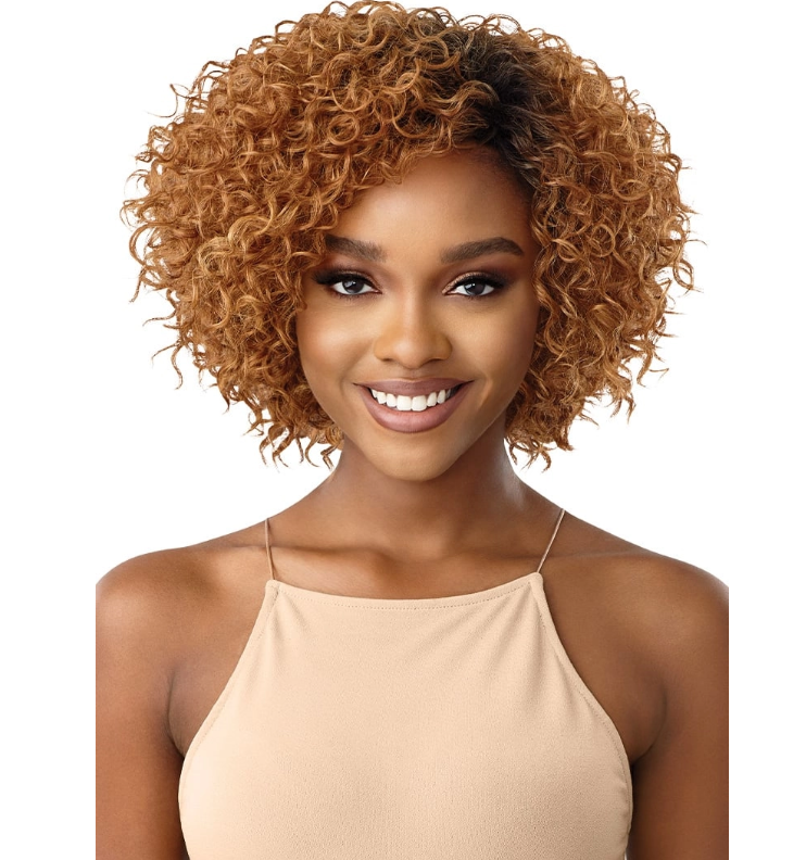 Woman with styled hair wearing a beige top on a white background