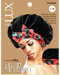 Thumbnail for A woman wearing an x-large luxury silky velvet tie bonnet in black with a patterned satin bow on the band.