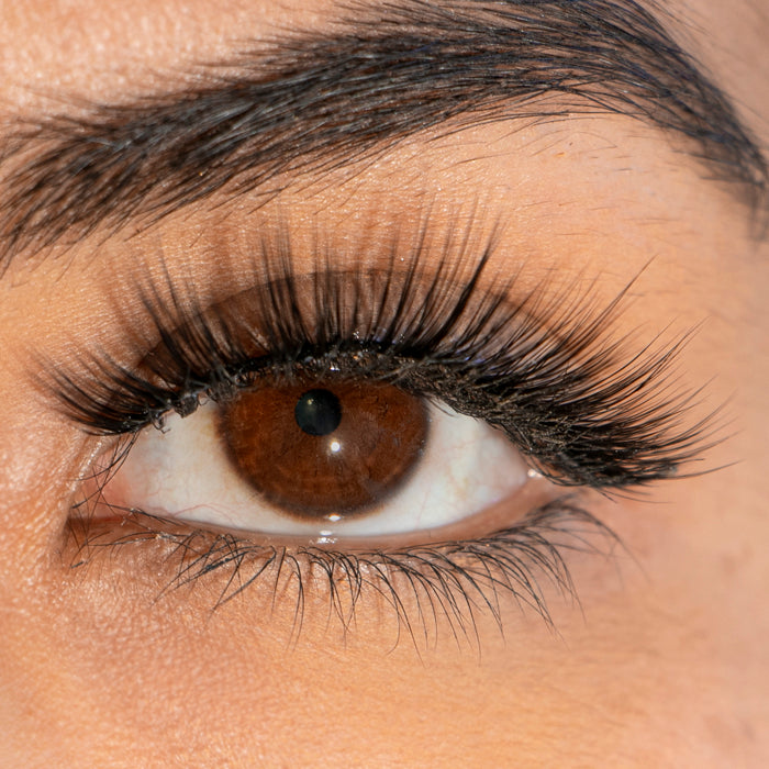 Close-up of an eye with a Brazilian silk eyelashes, showcasing the lashes' length and thickness.