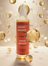 Thumbnail for Reviv2Grow Argan Essence hair oil bottle on a white surface with a gray background