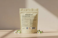 Thumbnail for Reviv2Grow Detox Hair Powder package on a wooden surface with flowers