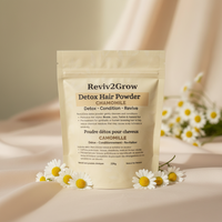 Thumbnail for Reviv2Grow Detox Hair Powder package with chamomile flowers on a soft background
