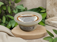 Thumbnail for Container of Reviv2grow Mango Butter on a wooden coaster with green leaves in the background