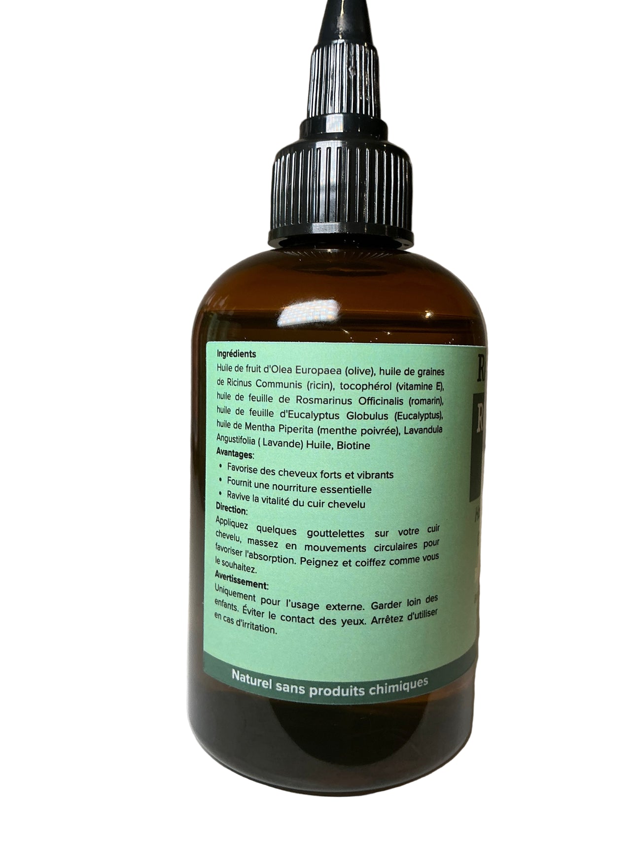 Bottle with a green label on a white surface