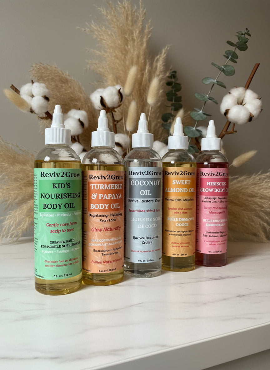 Row of body oils with visible labels on a gray surface