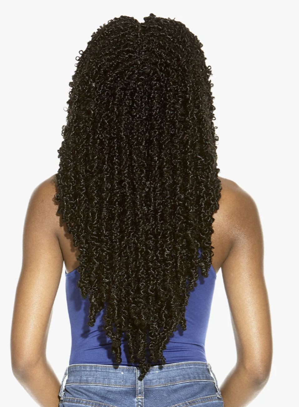 Person with long, styled hair on a plain background