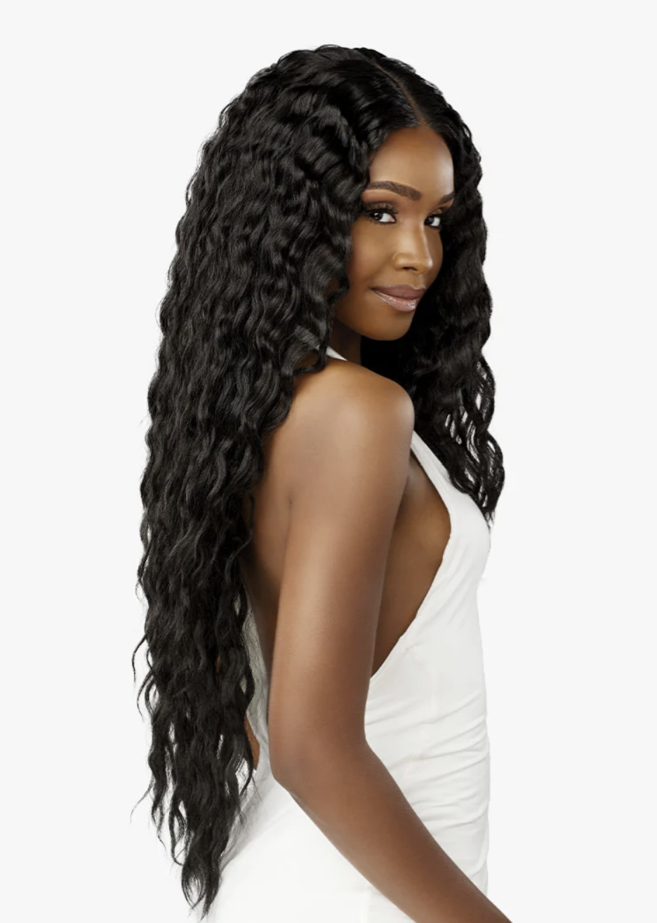 Woman with long, wavy black hair wearing a white dress on a light gray background