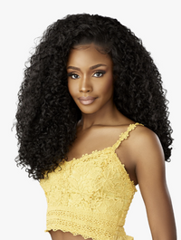 Thumbnail for Woman with long, curly black hair wearing a yellow lace top on a white background