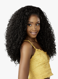 Thumbnail for Woman with voluminous curly hair wearing a yellow lace top on a white background