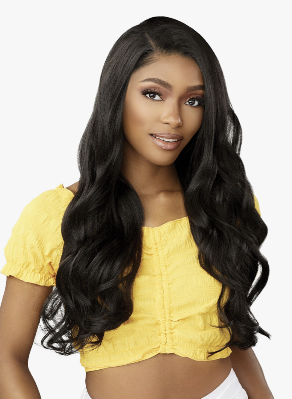 Woman with long, wavy black hair wearing a yellow top on a white background