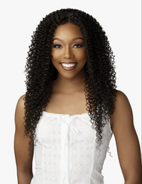 Thumbnail for Woman with long, curly black hair wearing a white top on a plain background
