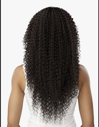 Thumbnail for Person wearing a wig with long, curly black hair on a white background