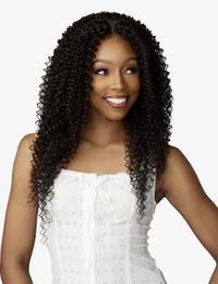 Thumbnail for Woman with long, curly hair wearing a white top on a white background