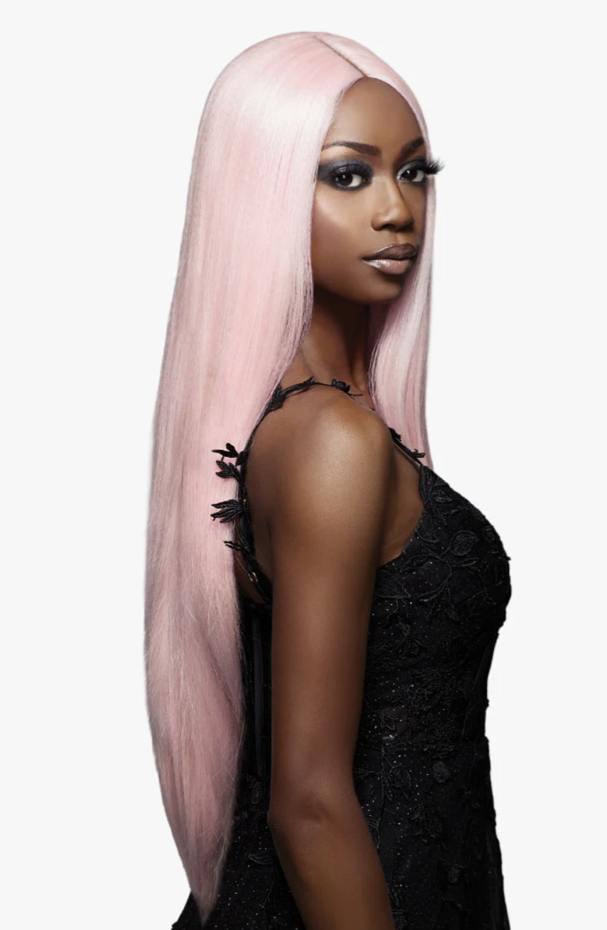 Woman with long pink hair wearing a black lace top on a white background