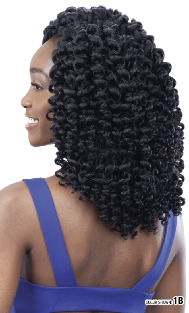 Woman with voluminous, curly hair styled in an updo, wearing a blue top.