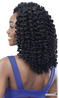 Thumbnail for Woman with voluminous, curly hair styled in an updo, wearing a blue top.