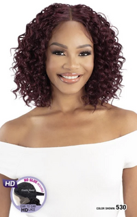 Thumbnail for Woman with styled hair, wearing a white top, with a brand logo in the corner.