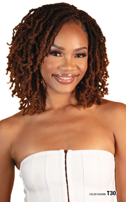 Woman with styled hair wearing a white strapless top on a plain background