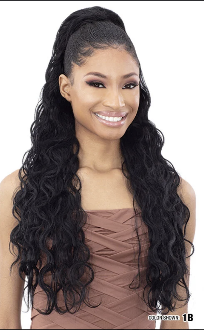 Woman with long, wavy black hair styled in a ponytail on a white background