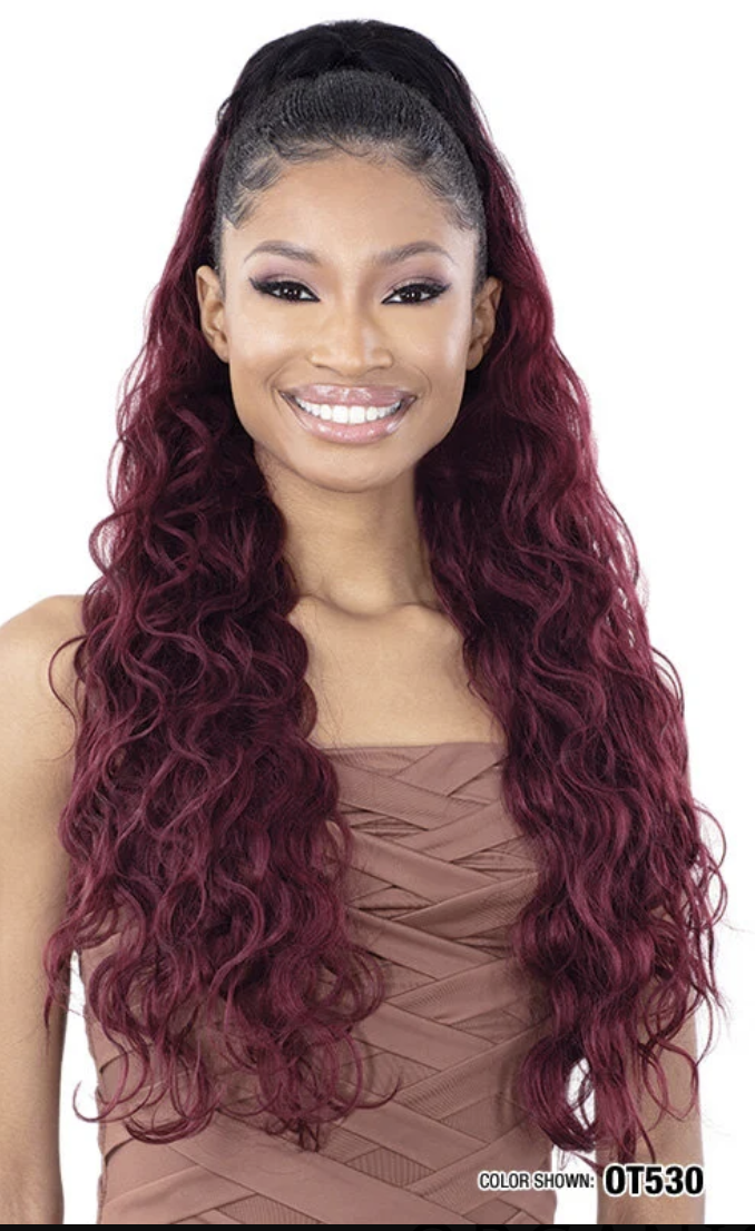 Woman with long, wavy, burgundy hair on a white background