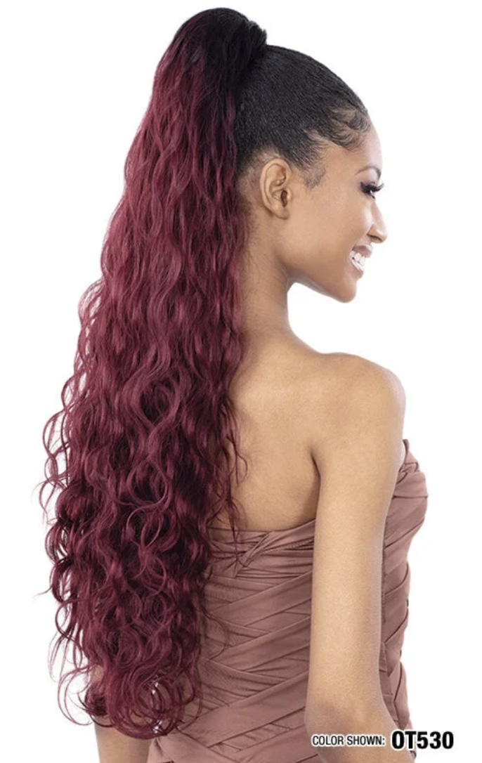 Woman with long, wavy, burgundy hair styled in a ponytail on a white background